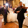 This is an image of Christos playing violin at a wedding ceremony