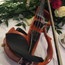 This is an image of an electric violin set in a floral bouquet.