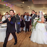This is an image of Christos playing a couple into the hall at a wedding.